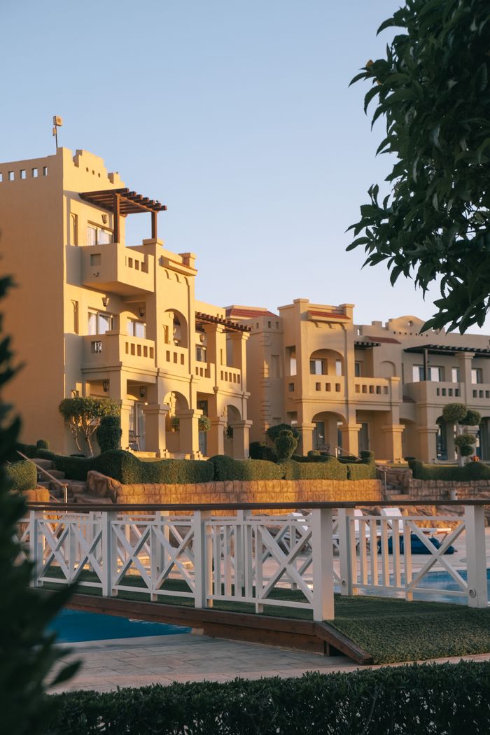 Elegant resort buildings with sunset hues, perfect for luxury travel themes.